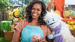 米歇尔·奥巴马的netflix新剧《Waffles and Mochi》的宣传照片显示米歇尔和三个木偶合影。其中一个是戴着围巾头上戴着华夫饼的雪人，另一个是戴着眼镜和领带的蜜蜂，最后一个是一个粉红色的糯米团